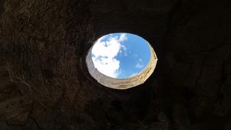 hole in the stone ceiling with a view of the sky