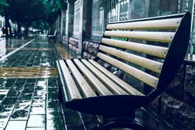 bench at the train station in the rain