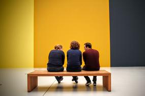 discussion of people on a bench in a museum