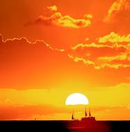 ship sailing against the sunset