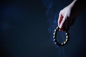 wooden beads in hand