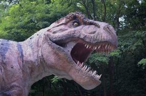 large dinosaur sculpture in the park