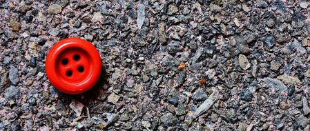 little red button on the stone beach