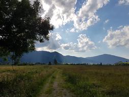 clouds background field field mountain view