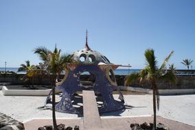 old iron colored gazebo on the beach