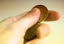 hand holds gold coins