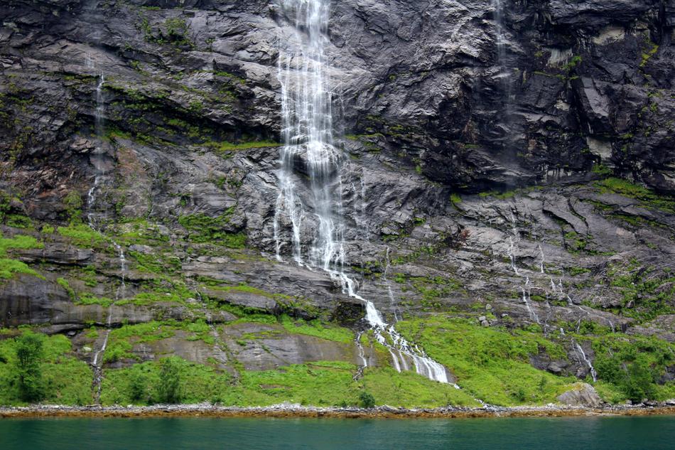 high rock with a waterfall