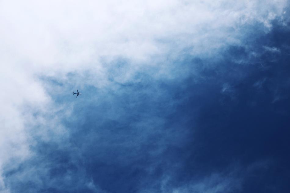 airplane flying far away in the sky