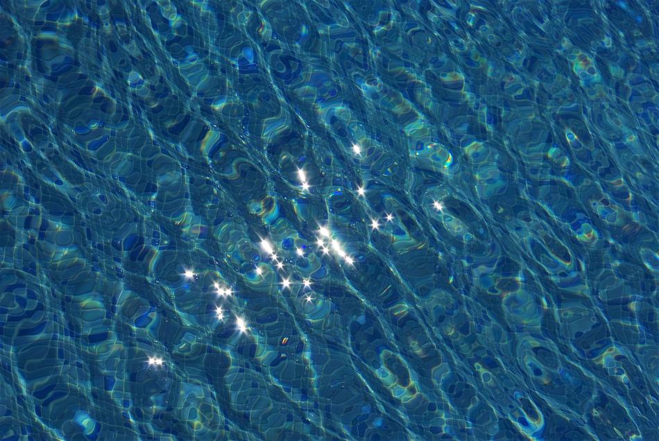 reflection of the sun in the blue water