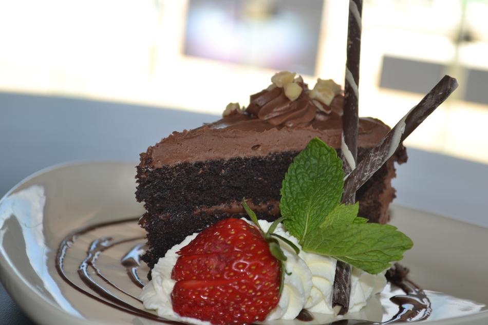 Chocolate cake with cream and strawberries