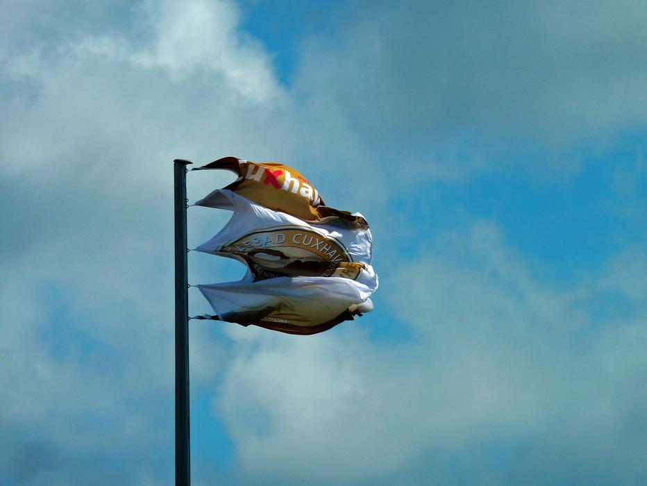 colored flags on a pole against the sky