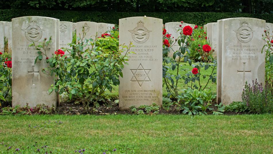 grave stones in the cemetery decorated with flowers