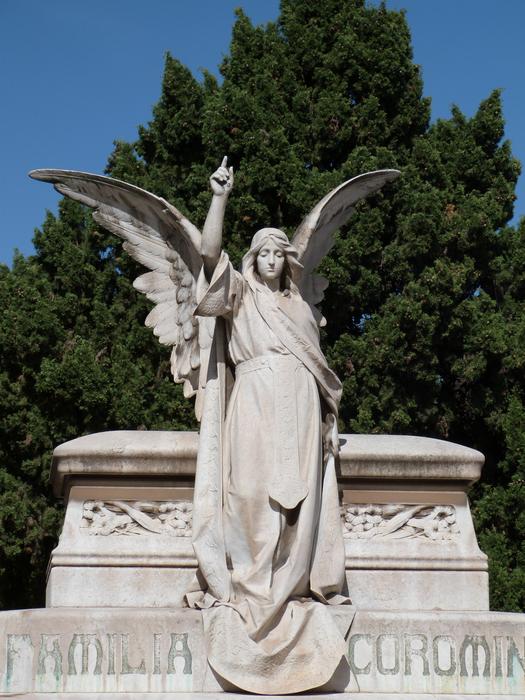 stone sculpture of an angel in a cemetery white