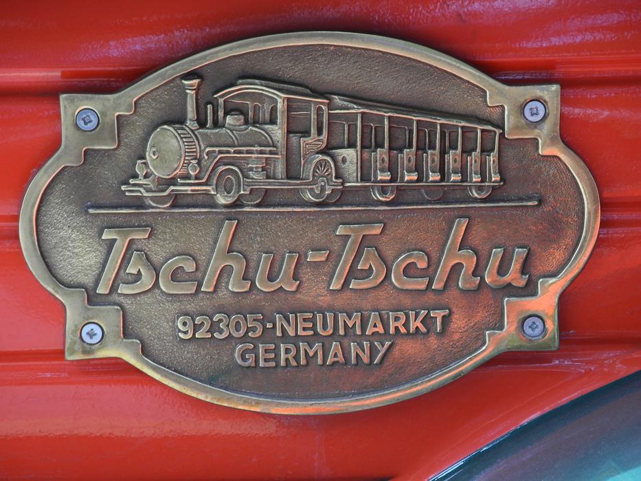 iron sign with a train on a wooden wall