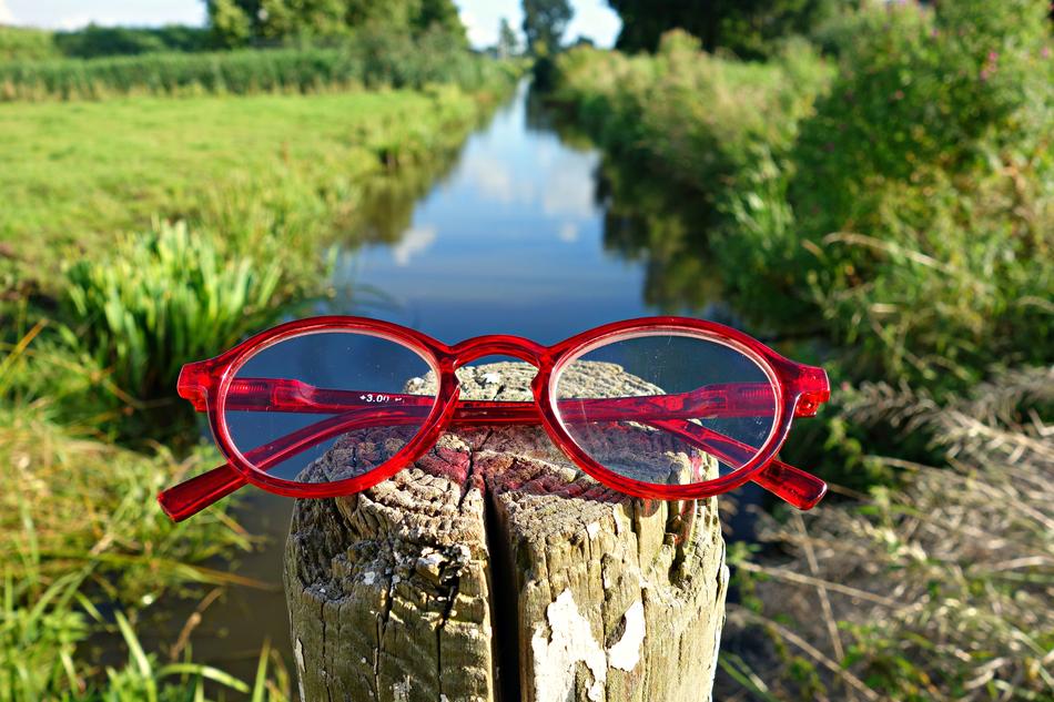 red frame glasses by the river