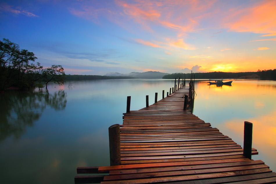 A wooden bridge that goes into the distance