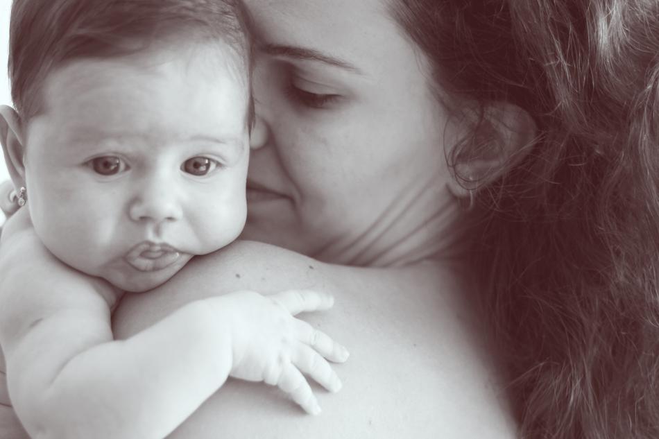 mother with her baby on her shoulder