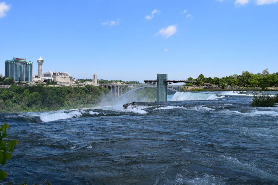 waterfall with a view of the city and the bridge