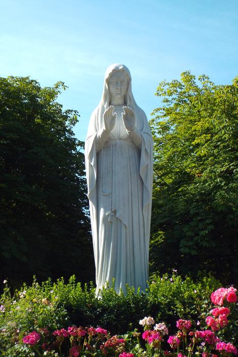 sculpture of saint mary among flowers