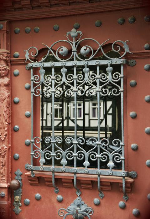 An iron door with a beautiful lattice