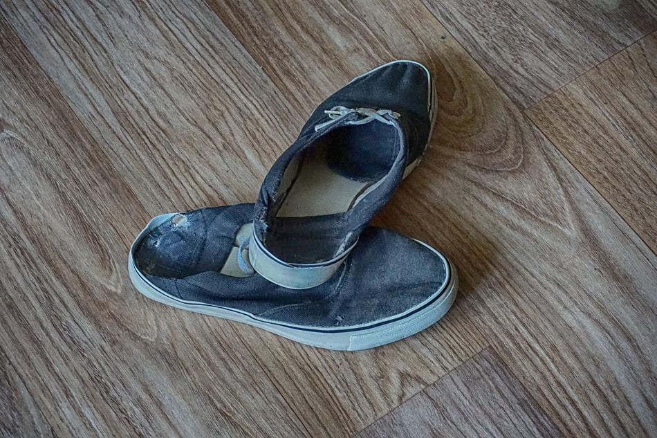 A man home shoes are torn