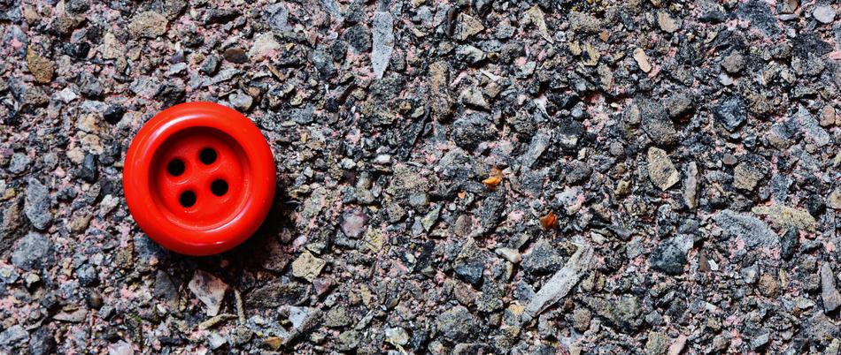 little red button on the stone beach