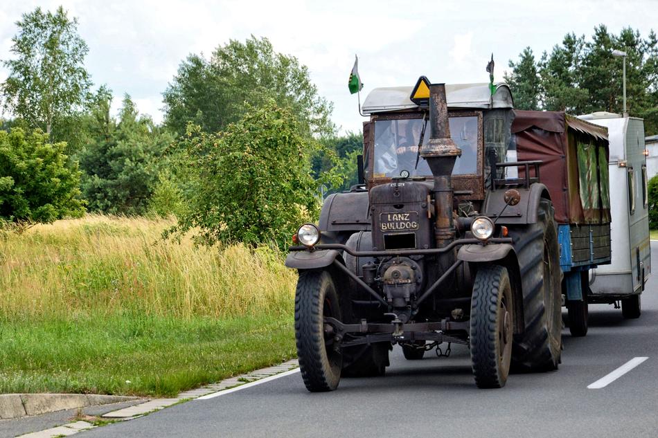 old tractor driving down the road