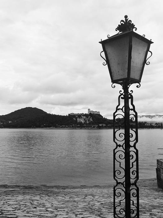 black and white, street lamp on the background of lake arona