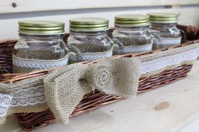 jars with spices in the basket in the kitchen
