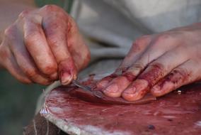 man cuts up raw meat