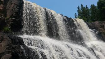 beautiful view of the waterfall with the rocks