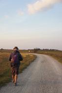 man on the road in a field view