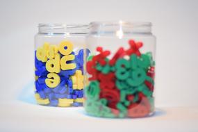 colored plastic letters with numbers in a jar