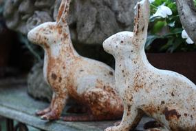 rusty garden decoration in the form of hares