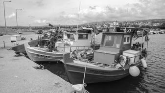 large boats at the pier black and white