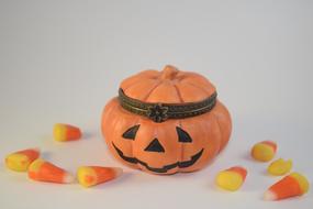 Funny pumpkin with a crown and candy