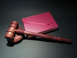 wooden hammer with a book on the table