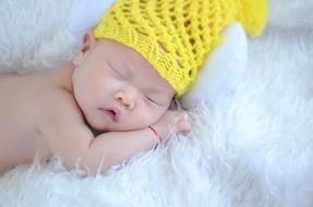 a small child in a yellow hat