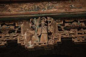 wooden carved figure on the ceiling