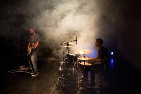 musicians on stage in the smoke