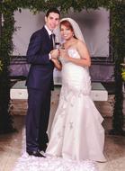 a bride in a long dress with her groom