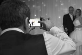 the photographer and the couple at the wedding