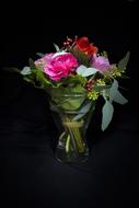 fresh flowers in a vase on a black background