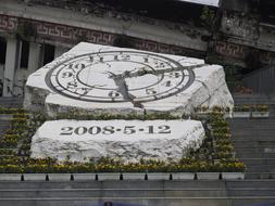 stone slab with clock and flowers