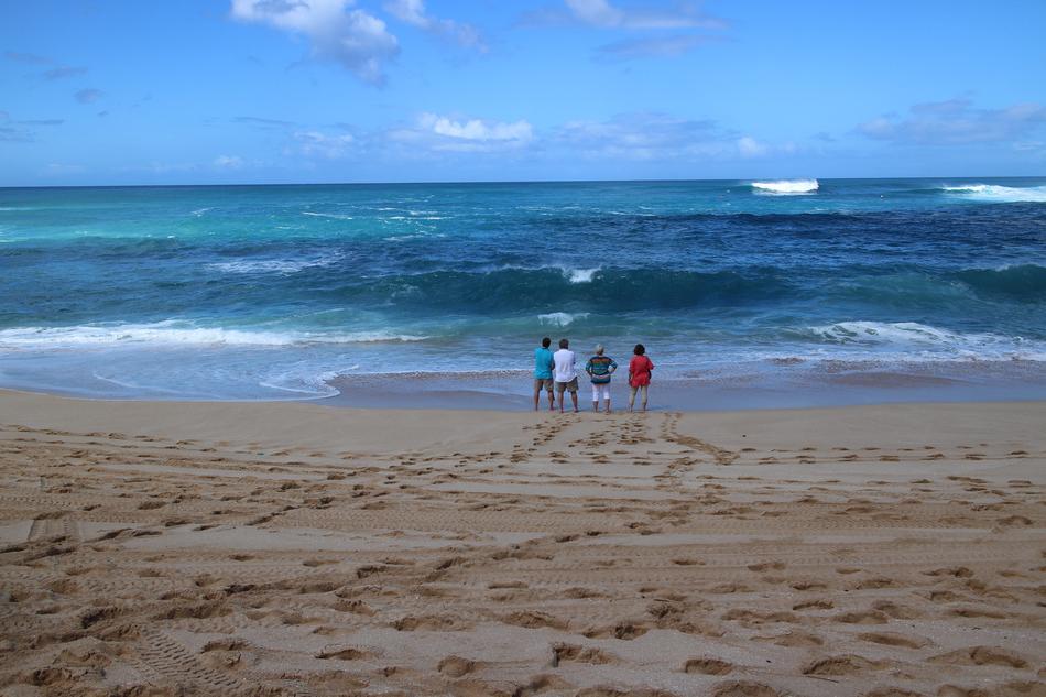 family walking by the sea
