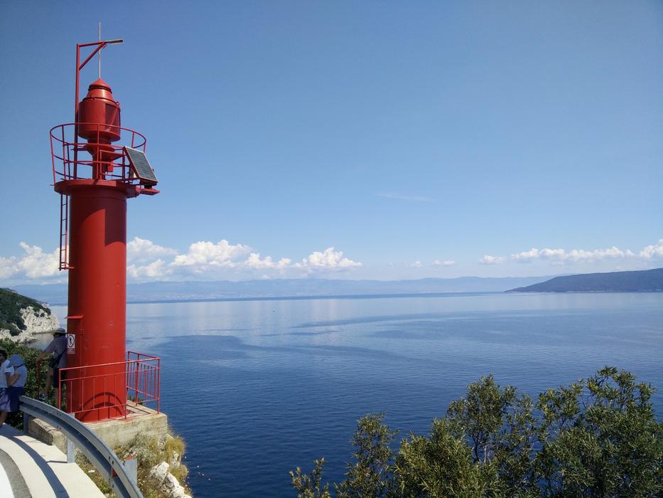 red lighthouse on the rock