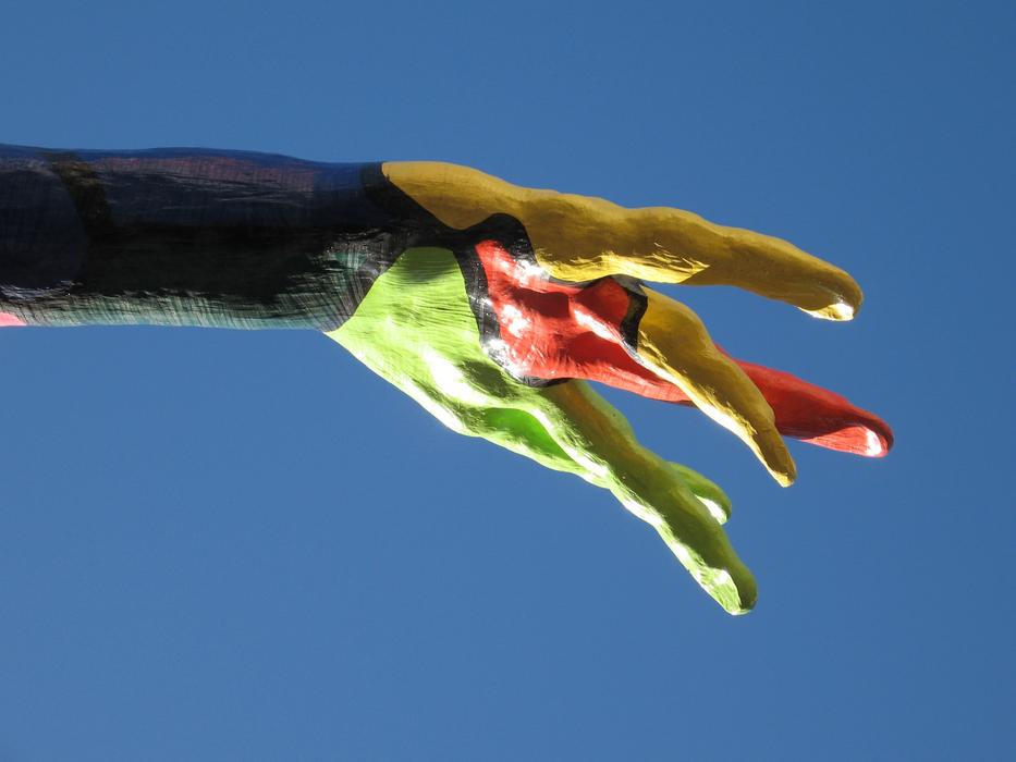 colored hand on sculpture