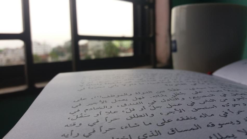 book with inscriptions open at the window