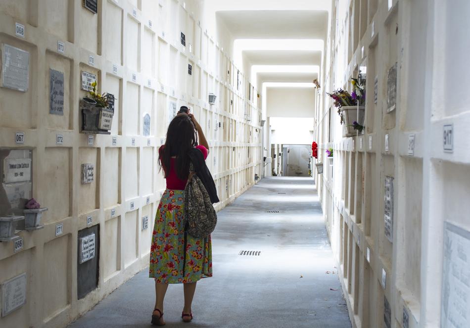A girl in a dress walks down the corridor