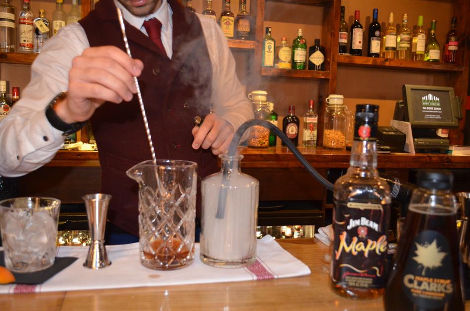 making an alcoholic cocktail at the bar